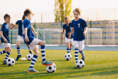 group of kids playing soccer